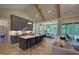 Bright, open kitchen with gray cabinetry, large island with seating, and stainless appliances at 4628 Rogers Rd, Wake Forest, NC 27587