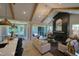 Open-concept living room boasts vaulted ceilings, exposed beams, and a cozy fireplace feature wall at 4628 Rogers Rd, Wake Forest, NC 27587