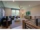 Open living room with modern decor, great natural light, and a view from the staircase at 4628 Rogers Rd, Wake Forest, NC 27587