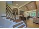 Open-concept living space with modern staircase, kitchen, and dining area, perfect for entertaining at 4628 Rogers Rd, Wake Forest, NC 27587