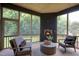 Relaxing screened porch with a brick fireplace and comfortable seating for outdoor enjoyment at 4628 Rogers Rd, Wake Forest, NC 27587