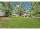 Spacious backyard featuring lush green grass, trees, and a fence at 5002 Kendridge Dr, Durham, NC 27712
