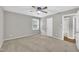 Neutral bedroom features carpet, a ceiling fan, and natural light from a window at 5002 Kendridge Dr, Durham, NC 27712
