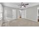 Neutral bedroom features carpet, two doors, a ceiling fan, and natural light from a window at 5002 Kendridge Dr, Durham, NC 27712
