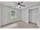 Neutral bedroom has gray walls, carpet, a ceiling fan, a closet, and natural light at 5002 Kendridge Dr, Durham, NC 27712