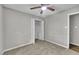 Neutral bedroom features carpet, a ceiling fan, and a closet with an open door at 5002 Kendridge Dr, Durham, NC 27712