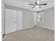 Neutral bedroom with carpet, a ceiling fan, two closets, and natural light from a window at 5002 Kendridge Dr, Durham, NC 27712