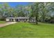 Well-maintained single-story home with a spacious yard and attached carport, perfect for outdoor living at 5002 Kendridge Dr, Durham, NC 27712