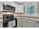 Beautifully remodeled kitchen with stainless steel appliances, granite counters, and updated cabinetry at 5002 Kendridge Dr, Durham, NC 27712