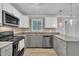 Updated kitchen boasts stainless steel appliances, granite countertops, and stylish cabinetry at 5002 Kendridge Dr, Durham, NC 27712