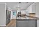 Modern kitchen with island, granite counters, stainless appliances, white and gray cabinets, and pendant lights at 5002 Kendridge Dr, Durham, NC 27712