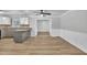 Open floorplan showing kitchen with granite countertops, appliances, and dining space with modern ceiling fan at 5002 Kendridge Dr, Durham, NC 27712