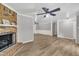 Spacious living room features a brick fireplace, wood-look floors, and a white wood-paneled ceiling at 5002 Kendridge Dr, Durham, NC 27712