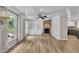 Living room featuring fireplace with brick surround, built in shelves and cabinets, ceiling fan, and wood floors at 5002 Kendridge Dr, Durham, NC 27712