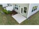 Concrete patio and door to the house with well-maintained green lawn for outdoor activities and enjoyment at 501 Hazy Hills Ln, Garner, NC 27529