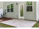 Spacious backyard concrete patio with a view of a door and windows to let in the light and fresh air at 501 Hazy Hills Ln, Garner, NC 27529