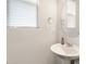 Cozy half-bathroom with a pedestal sink and round mirror at 501 Hazy Hills Ln, Garner, NC 27529