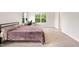 Bedroom boasts comfortable bed and a desk near the window with natural light at 501 Hazy Hills Ln, Garner, NC 27529