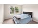 Cozy bedroom features a comfortable bed and a large window overlooking the backyard at 501 Hazy Hills Ln, Garner, NC 27529