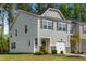 Charming gray two-story home with a one-car garage and well-maintained landscaping at 501 Hazy Hills Ln, Garner, NC 27529