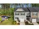 Aerial view of a gray two-story home with one-car garage and manicured lawn at 501 Hazy Hills Ln, Garner, NC 27529