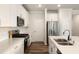 Contemporary kitchen featuring white cabinetry, stainless steel appliances, and a large kitchen island at 501 Hazy Hills Ln, Garner, NC 27529