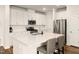 Bright kitchen with white cabinets, stainless steel appliances, and a central island with seating at 501 Hazy Hills Ln, Garner, NC 27529
