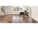 Open living area with wood flooring, a stairway, and windows for abundant natural light at 501 Hazy Hills Ln, Garner, NC 27529