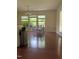 Bright dining area with hardwood floors, three windows and a modern chandelier at 525 Abbey Fields Loop, Morrisville, NC 27560