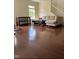 Bright living room with hardwood floors, sectional sofa, and a window for natural light at 525 Abbey Fields Loop, Morrisville, NC 27560