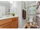 Bathroom with a single sink vanity, wood-look flooring, and toilet at 5932 Johnson Pond Rd, Fuquay Varina, NC 27526