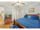 Comfortable bedroom featuring a wood-framed bed, ceiling fan, and hardwood floors at 5932 Johnson Pond Rd, Fuquay Varina, NC 27526