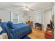 Bedroom with hardwood floors, two windows, ceiling fan and a blue bed at 5932 Johnson Pond Rd, Fuquay Varina, NC 27526