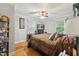 Cozy bedroom with hardwood floors, fan, and a television at 5932 Johnson Pond Rd, Fuquay Varina, NC 27526