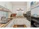 Cozy kitchen features granite countertops, stainless steel sink, appliances and white cabinets at 5932 Johnson Pond Rd, Fuquay Varina, NC 27526
