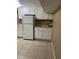 This kitchen features white cabinets, tile floor, and ample counter space at 5932 Johnson Pond Rd, Fuquay Varina, NC 27526