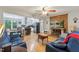 Spacious living room with hardwood floors, brick fireplace with TV, open to the kitchen and dining area at 5932 Johnson Pond Rd, Fuquay Varina, NC 27526