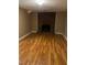 Open room featuring hardwood floors and brick fireplace at 5932 Johnson Pond Rd, Fuquay Varina, NC 27526