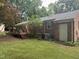 Exterior view of brick home with patio deck and green landscaped yard at 609 Malone Ct, Burlington, NC 27215