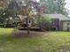 Brick house, backyard with patio deck, landscaping, and covered carport at 609 Malone Ct, Burlington, NC 27215