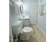 Bright bathroom with a single vanity, toilet, oval mirror and patterned flooring at 609 Malone Ct, Burlington, NC 27215