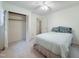 Cozy bedroom with neutral carpet, ceiling fan and closet with bifold doors at 609 Malone Ct, Burlington, NC 27215