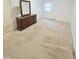 Bedroom featuring neutral carpet, a dresser with mirror, and a closet at 609 Malone Ct, Burlington, NC 27215