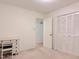Bedroom with neutral carpet, closet, and white desk and chair at 609 Malone Ct, Burlington, NC 27215