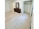 Spacious bedroom featuring neutral carpet, a closet, and a dresser with a mirror at 609 Malone Ct, Burlington, NC 27215