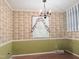 Dining room showcasing patterned wallpaper, a chandelier, and a window at 609 Malone Ct, Burlington, NC 27215