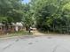 Shot of the front of a brick home on a tree-lined street and long driveway at 609 Malone Ct, Burlington, NC 27215