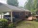 Brick home featuring covered carport, patio deck, and green landscaping at 609 Malone Ct, Burlington, NC 27215