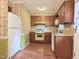 Functional kitchen with wood cabinets, a range, and a refrigerator at 609 Malone Ct, Burlington, NC 27215