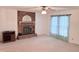 Bright living room featuring a brick fireplace, ceiling fan, and ample space at 609 Malone Ct, Burlington, NC 27215
